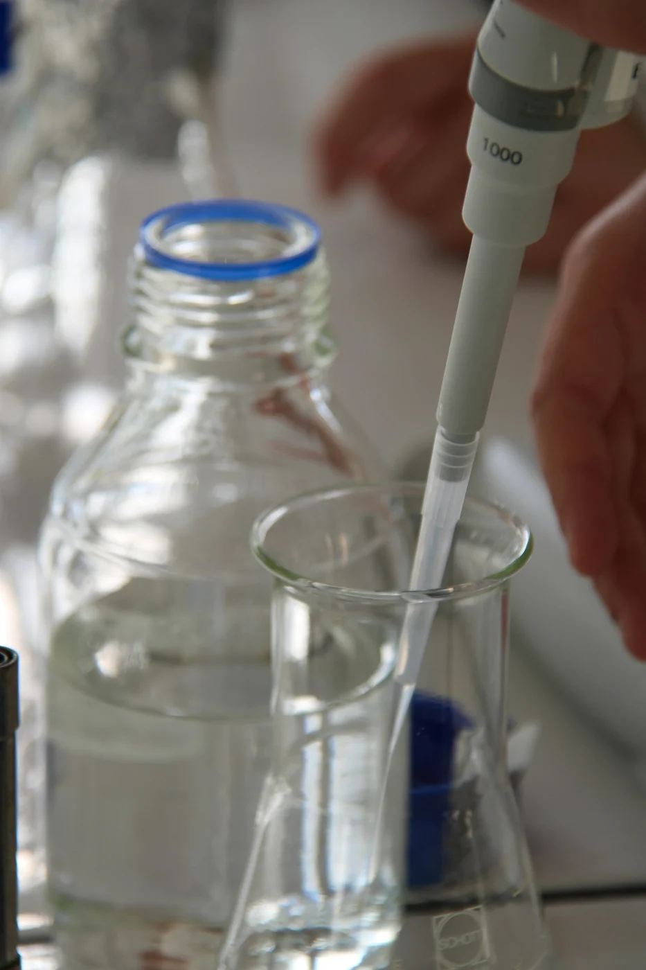 Using a micropipette in a laboratory. Experimental context photograph; it does not depict the AlertStrip prototype or establish its effectiveness.
