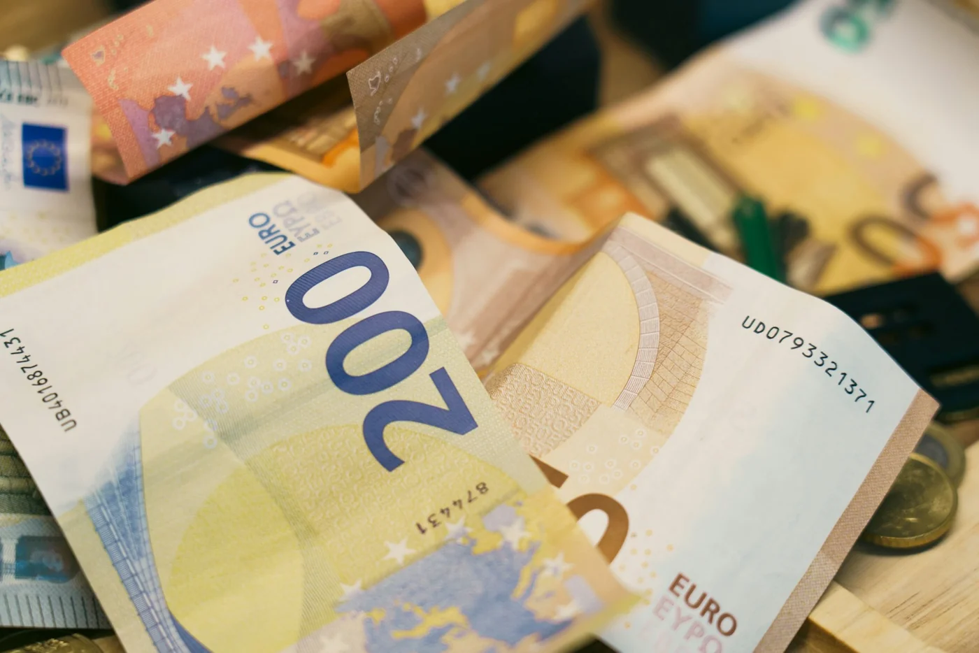 Euro banknotes and coins. Financial context photograph; it does not depict seized money or evidence from the operation.