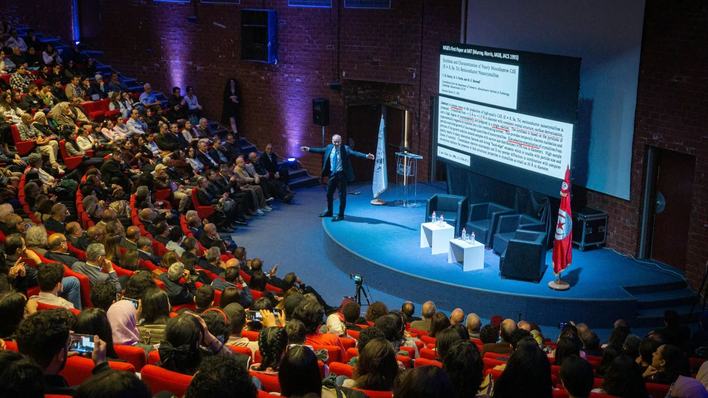 A presentation in an auditorium. Context for education and public information; this photograph is not from the La Oliva campaign sessions.