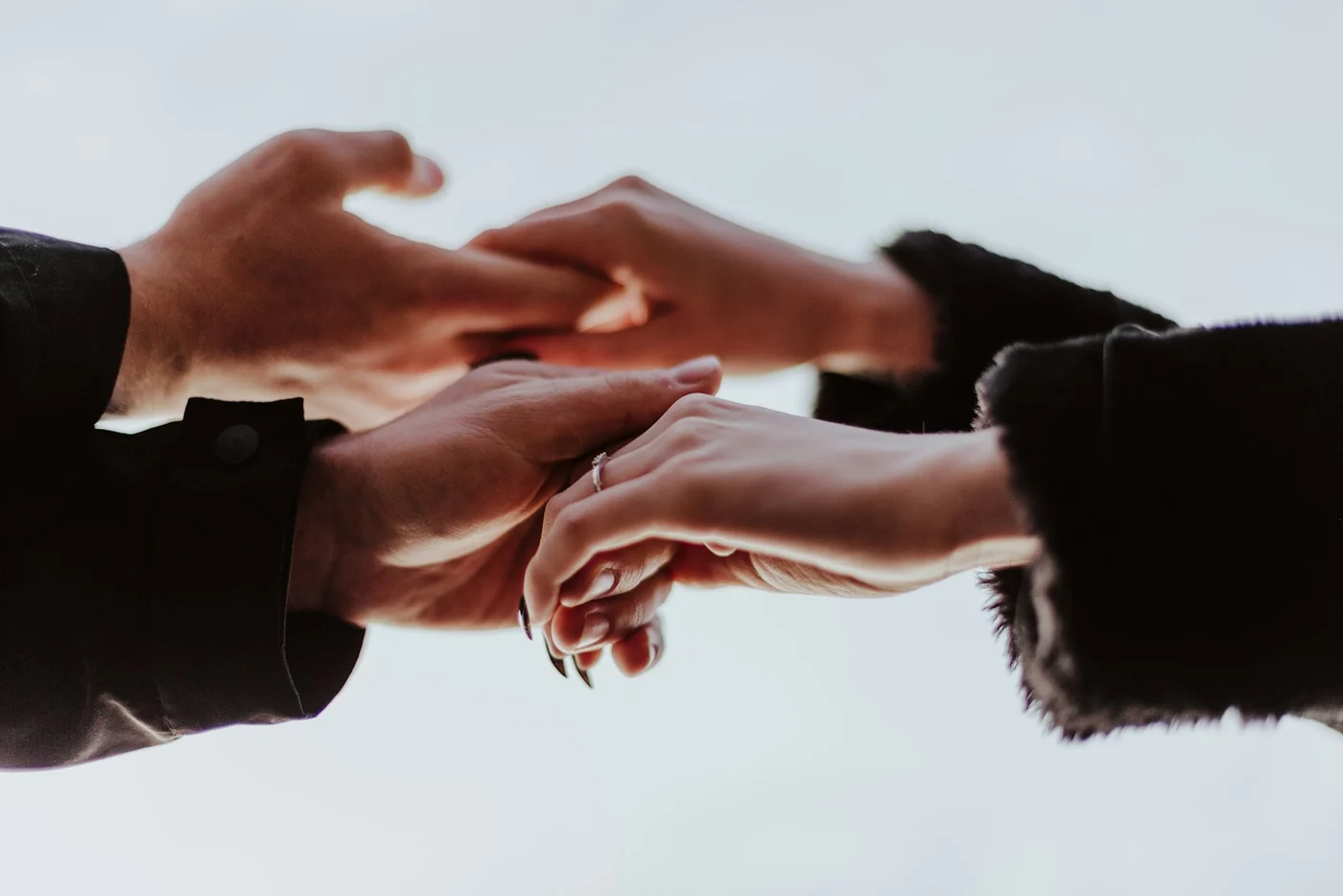 Two people holding hands. Context for companionship and support; the photograph does not identify victims or document a campaign intervention.