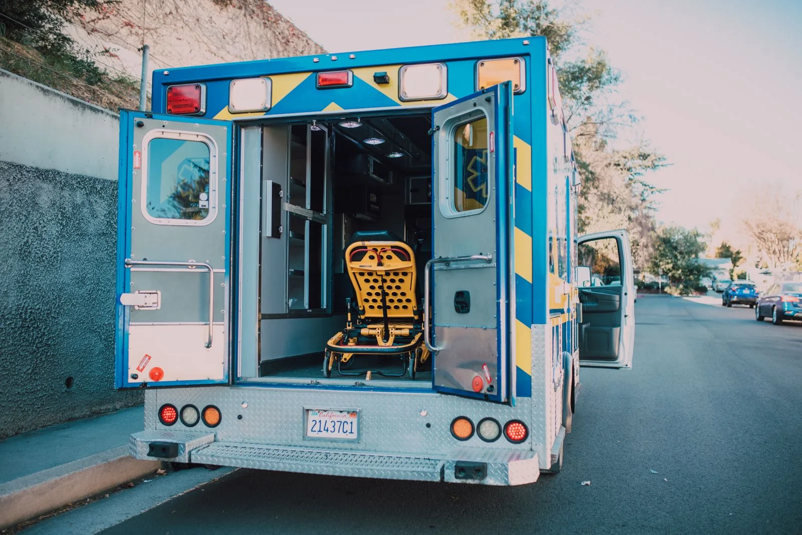 Open ambulance with a stretcher. Emergency-care stock photograph, not documentation of the Scottish service or a specific case.