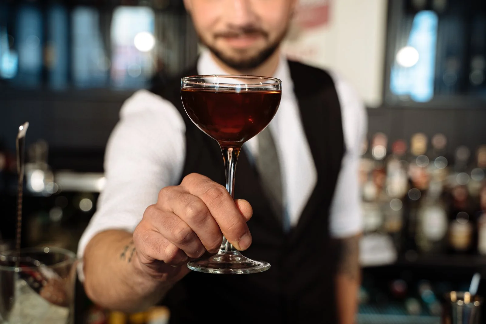 A drink being served at a bar. Hospitality stock photograph; the person and venue are unrelated to spiking incidents.
