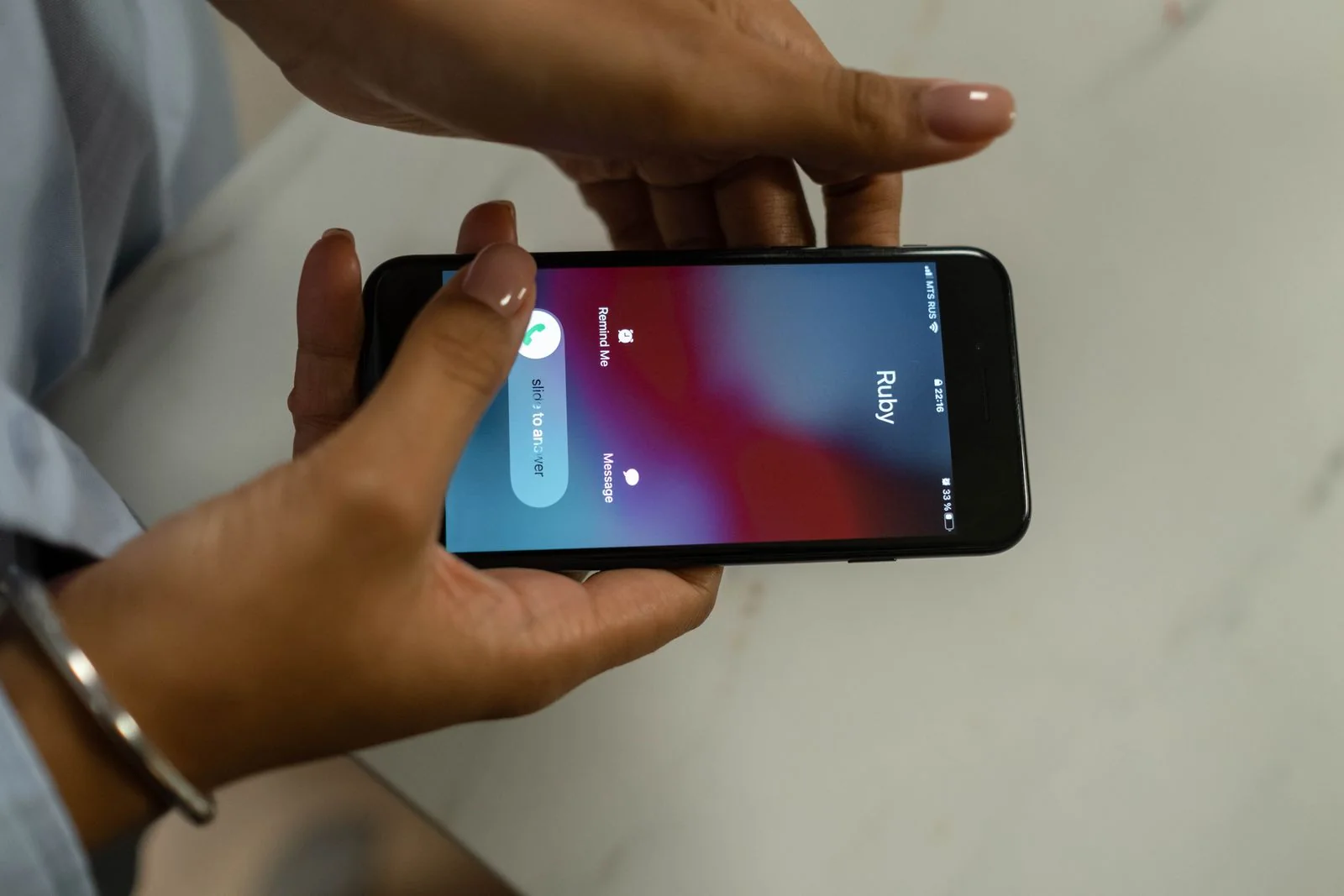 Hands holding a phone receiving a call. Communication and support stock photograph, not a call to the Cork centre.