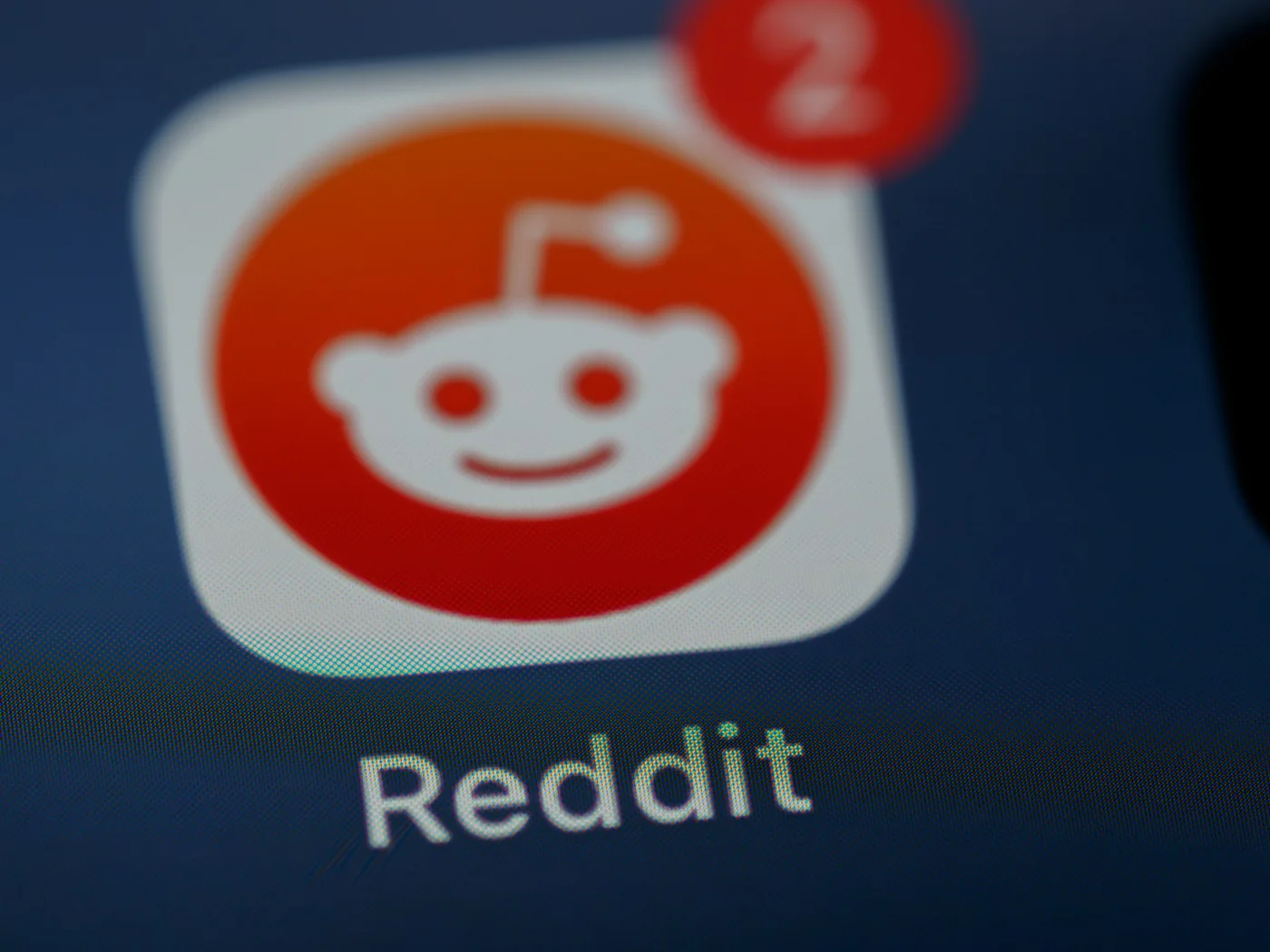 Reddit icon photographed on a screen. Context image for research into online conversations.